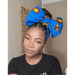 Load image into Gallery viewer, Black woman in Blue and yellow headwrap.
